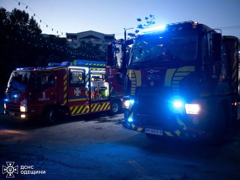 Пожежні автомобілі ДСНС Одеси з увімкненими синіми проблисковими маячками на місці ліквідації надзвичайної події у темну пору доби.